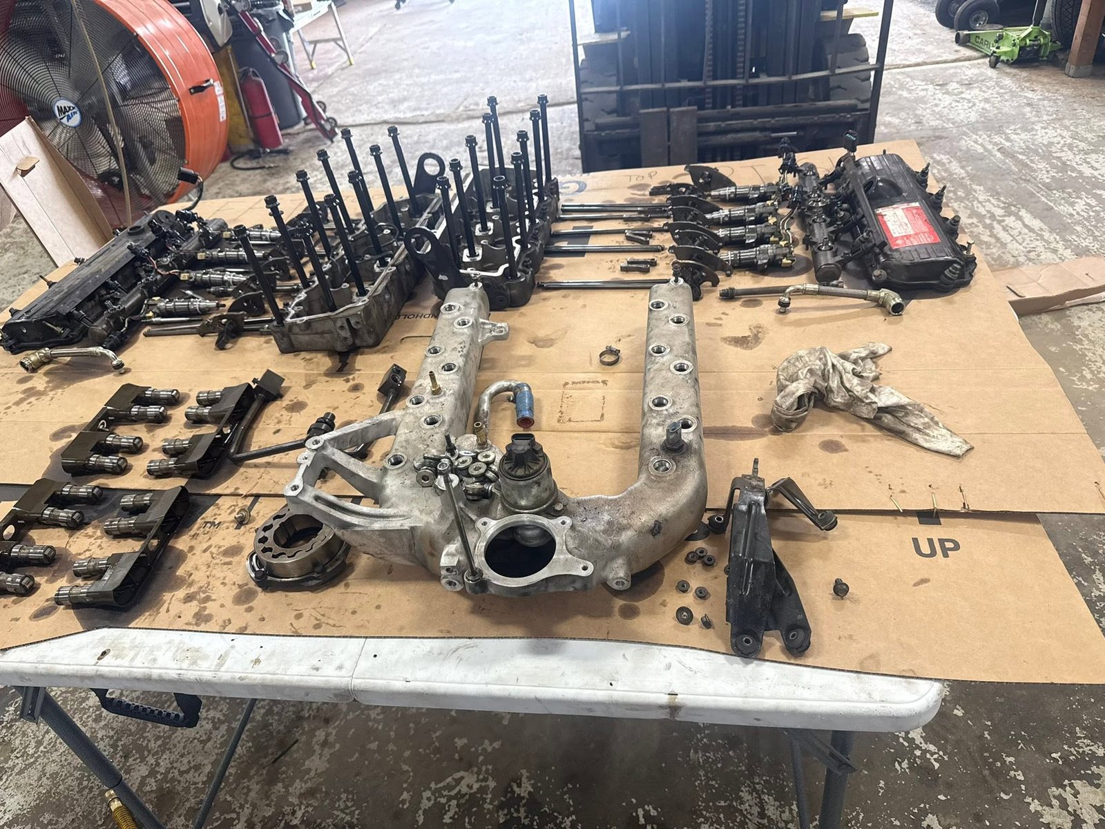 Engine components organized on a shop table